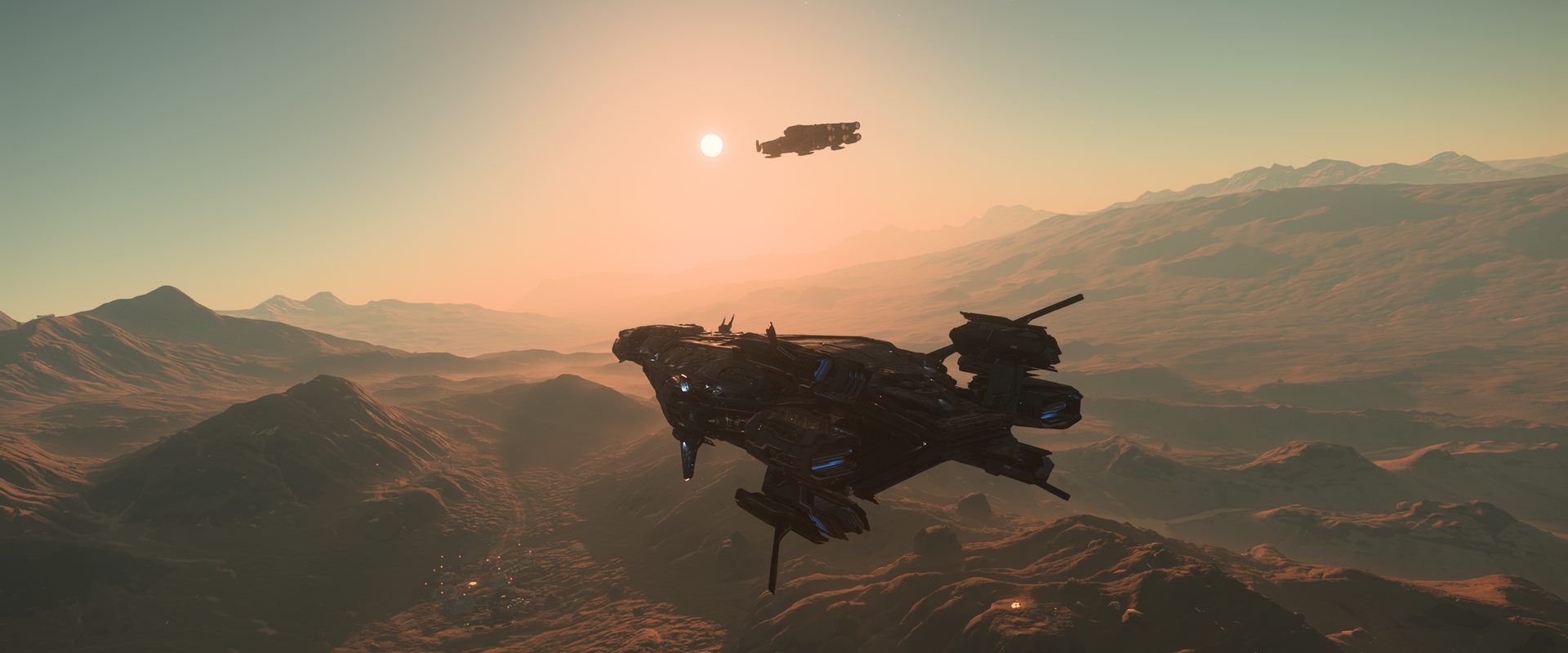 Un Polaris et un Ironclad survolant des montagnes au coucher du soleil, dans Star Citizen