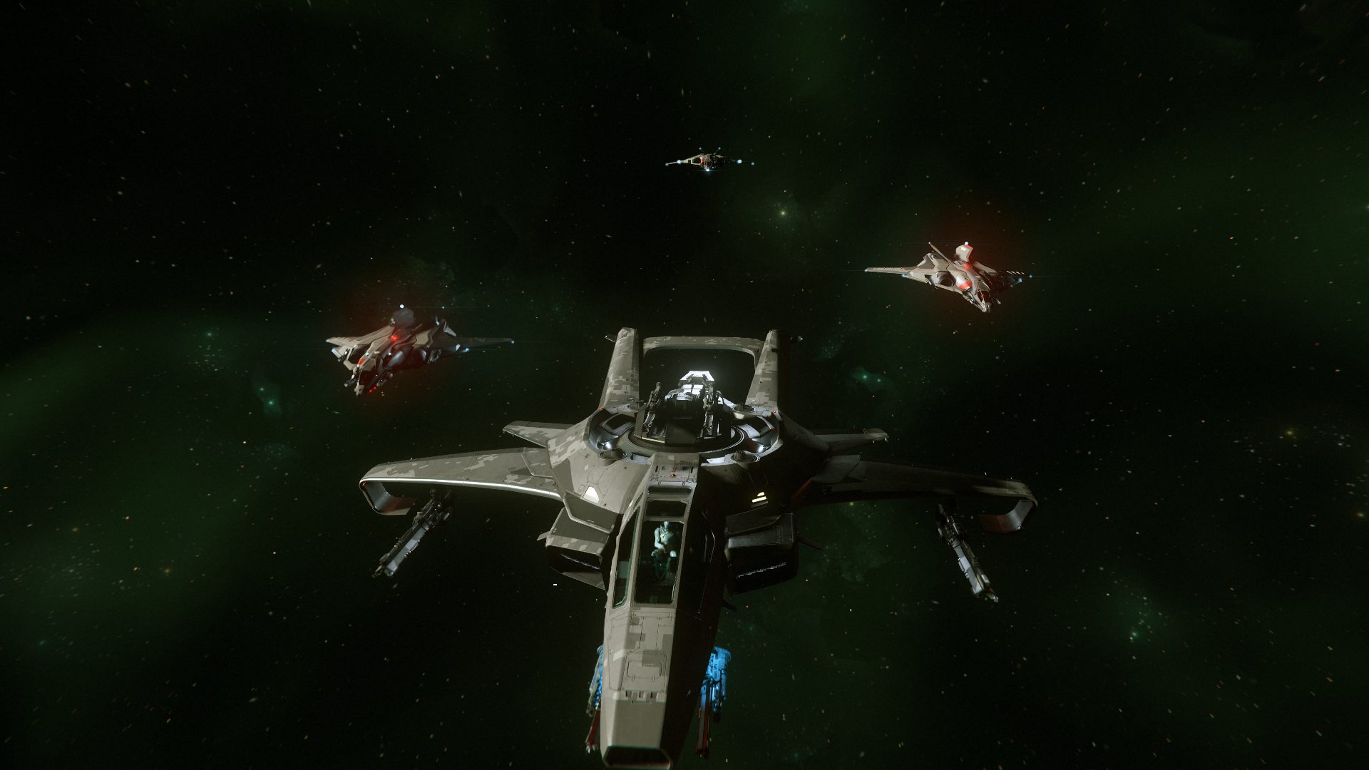 Quatre chasseurs volant en formation dans l'espace, sur fond de nébuleuse verte, dans Star Citizen